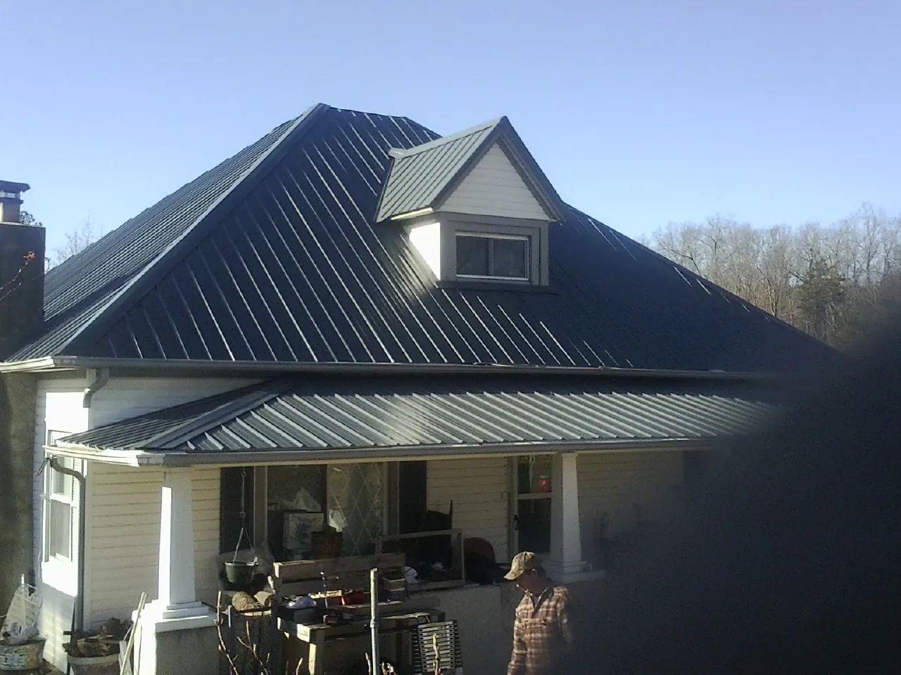 Dark blue standing seam metal roof with a dormer above a front porch in Varnville