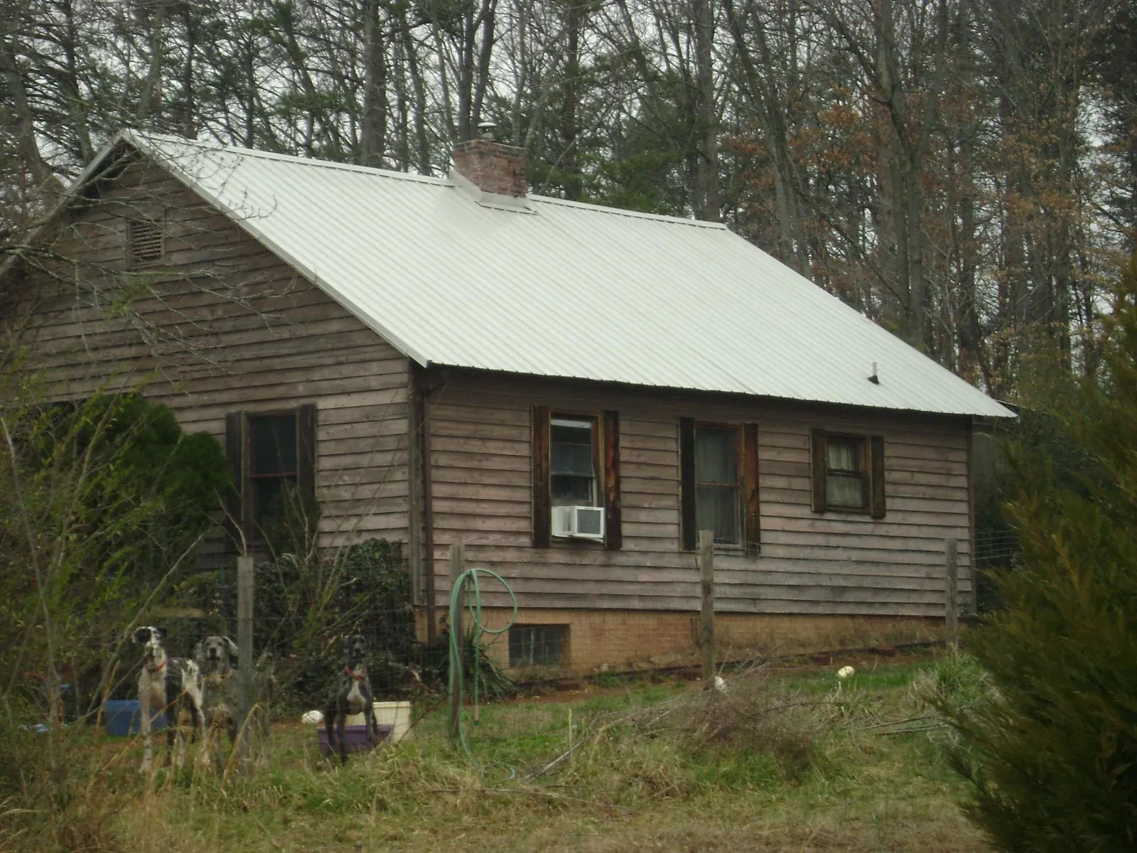 White metal roof on an old wood sided farmhouse, from a Metal Roof Installation job in Varnville
